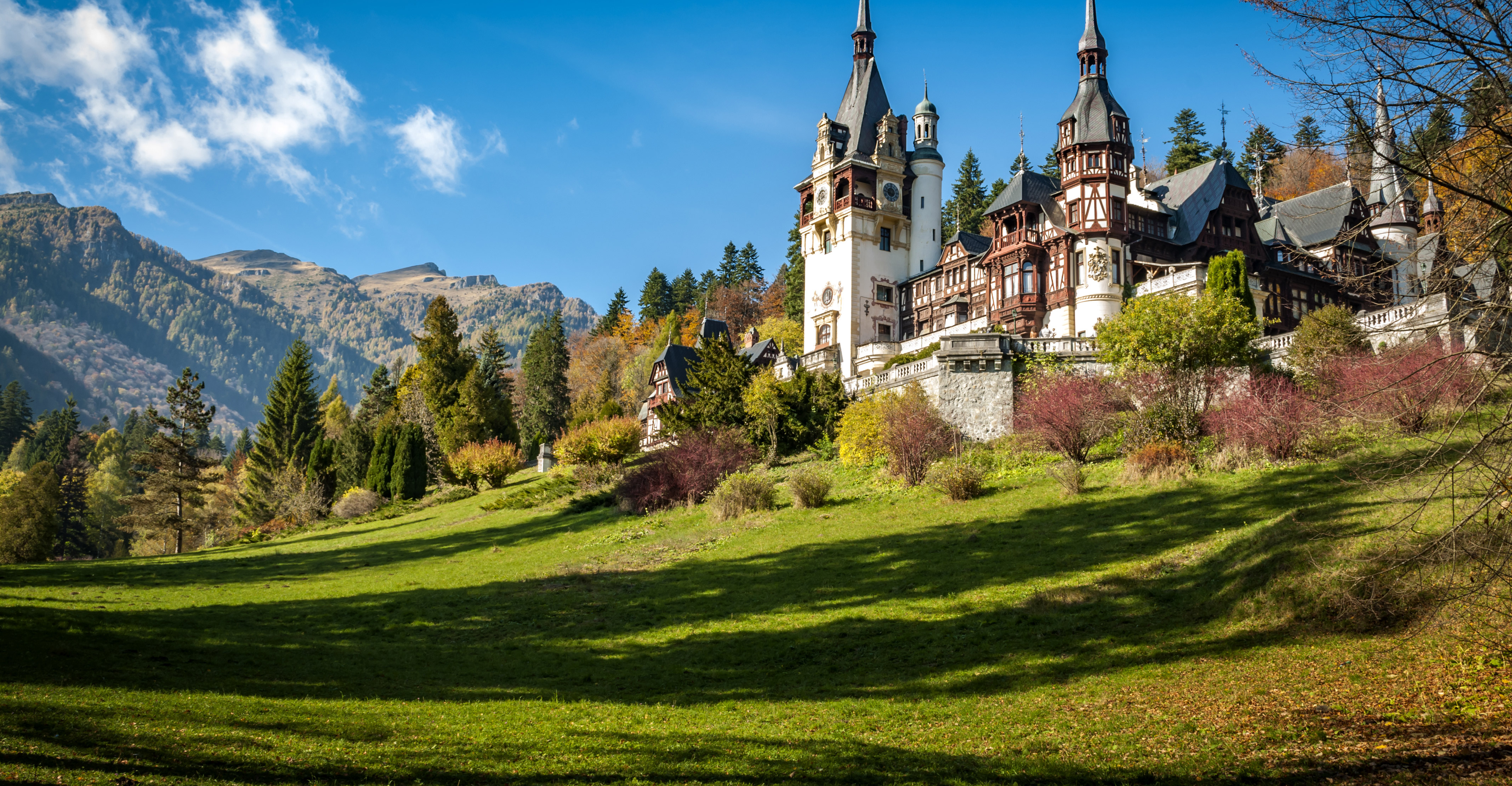 Image of Romania countryside with castle in background.